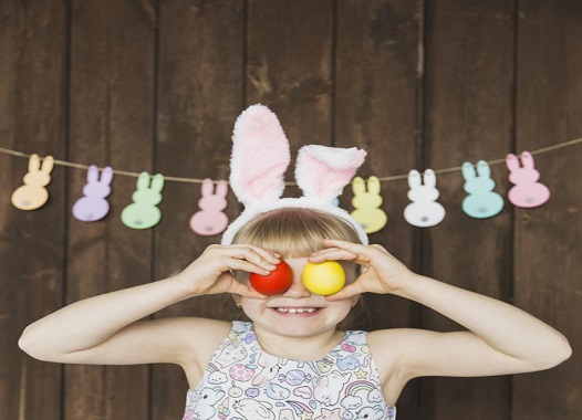 playful-girl-in-bunny-ears-with-eggs